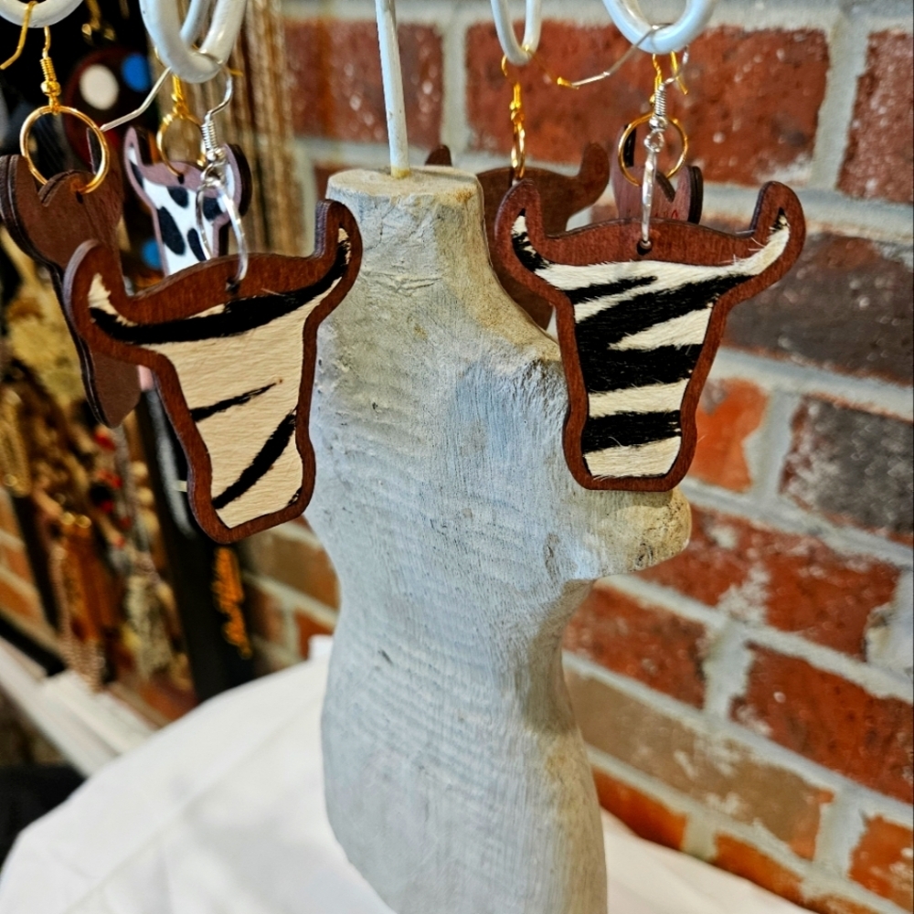 Rockin' Hot Originals cow earrings zebra print laid in dark wood